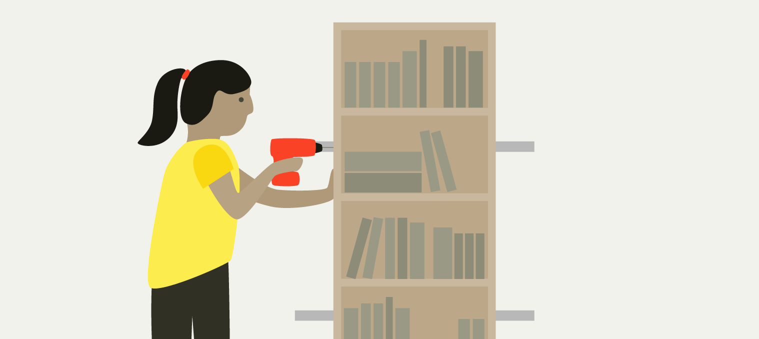 A woman attaching a bookcase to the wall with metal brackets and a drill.